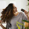 happy-woman-singing-into-hairbrush-home