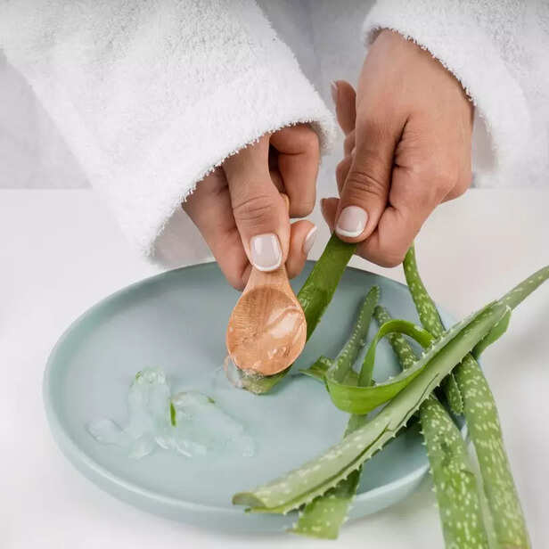 close-up-hands-taking-aloe-vera-gel
