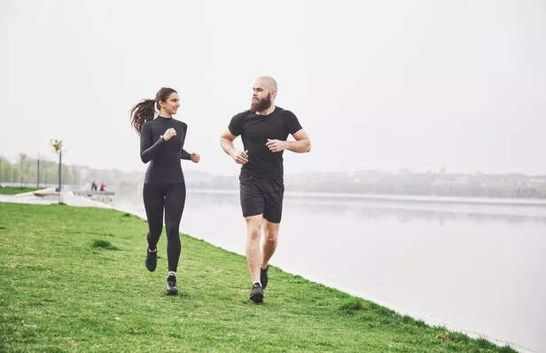 couple-jogging-running-outdoors-park-near-water-young-bearded-man-woman-exercising-together-morning