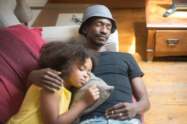 man sleeping with his kid peacefully