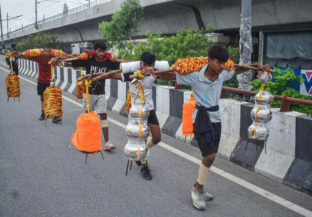 Meerut, Jun 29 (ANI)_ Kanwariyas carry pots filled with Ganga water, ahead of th....