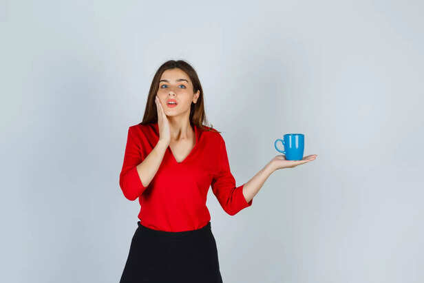 Woman with her coffee nearby.