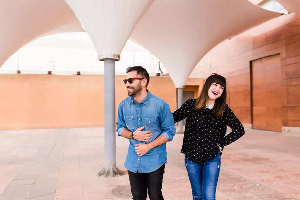 A couple laughing on a casual walk
