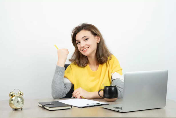 A young adult sitting at a desk with laptop