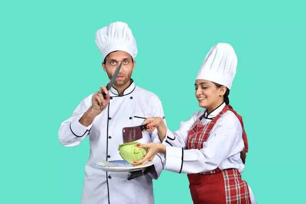 A husband and wife cooking