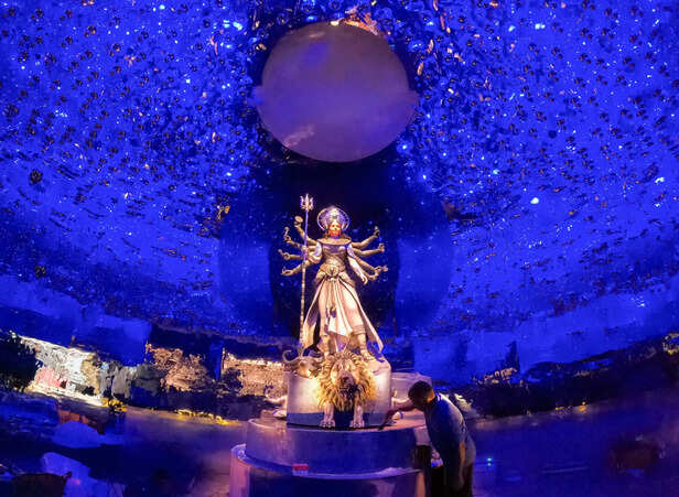 An artist gives a final touch to the idol of the Goddess