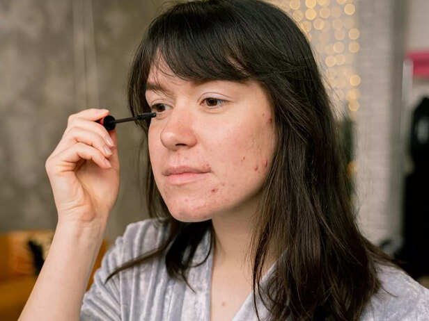 Woman applying castor oil on her lashes