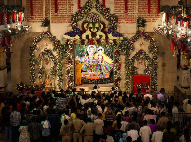 Devotees offer prayers to Lord Krishna