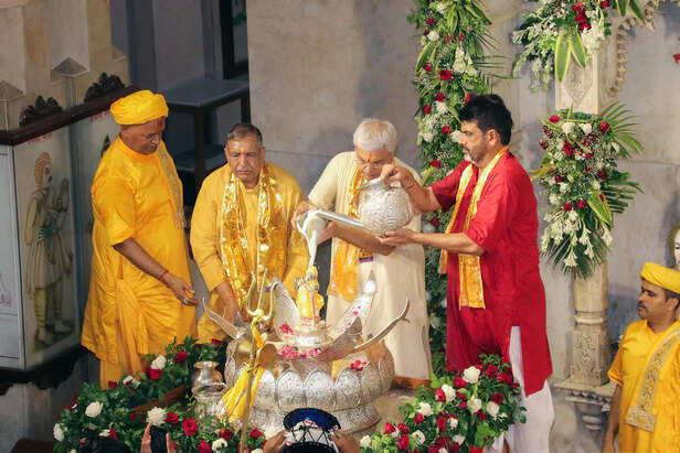 Priests perform the 'Abhishek' with milk to the idols