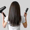 Women with hair dryer and hair brush