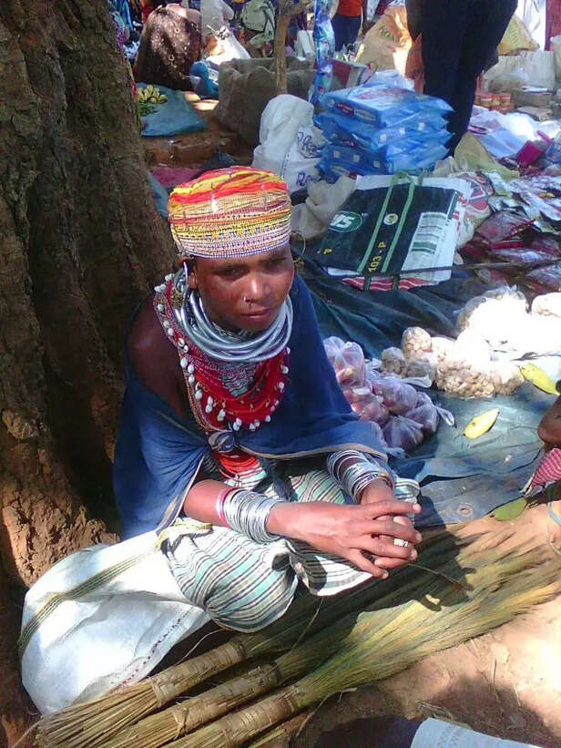 356741-a-tribal-girl-selling-brooms-in-a-hat-1