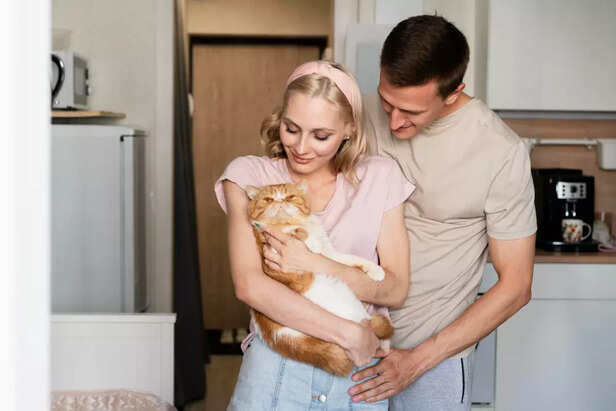 Cat Parents Sharing a Loving Moment With Their Pet Cat