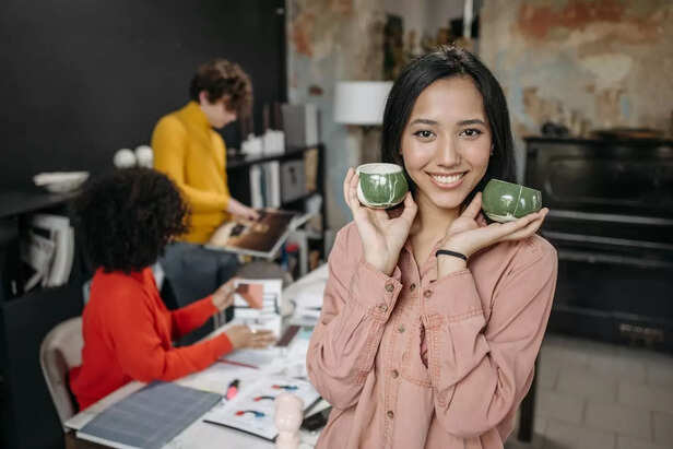 Women holding ceramic mugs