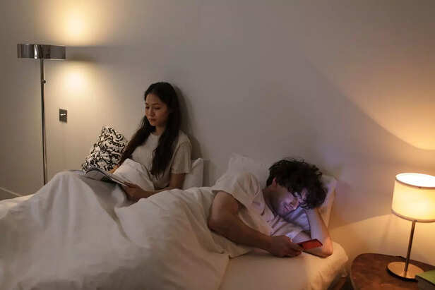 A Couple Sharing a Bed but Facing Opposite Directions