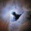 Hubble Captures Cosmic Keyhole Engulfed In Clouds Illuminated By A ...