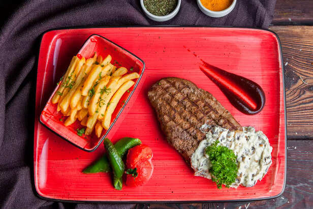 Steak With Ketchup and French Fries