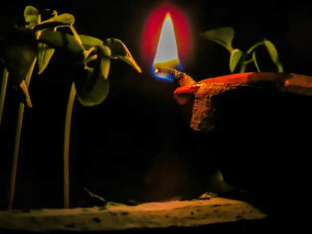 Lighting diya during evening prayers