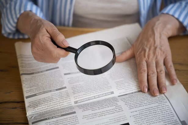 Magnifying glass over newspaper