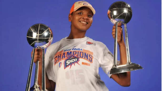 WNBA star Kara Braxton poses with two championship trophies in 2008.