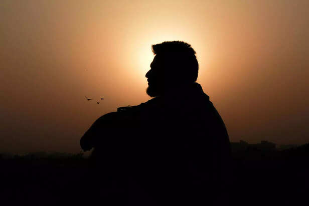 Person Sitting Peacefully During Sunrise Prayer