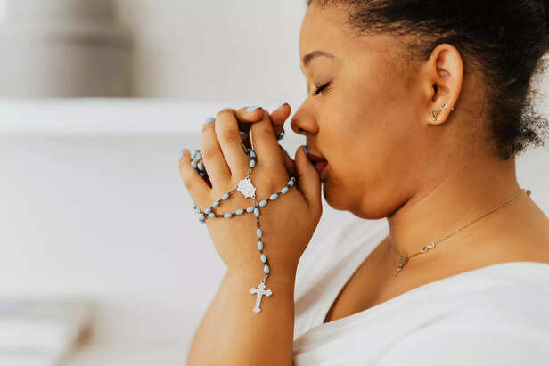 Person Praying With Hands Together