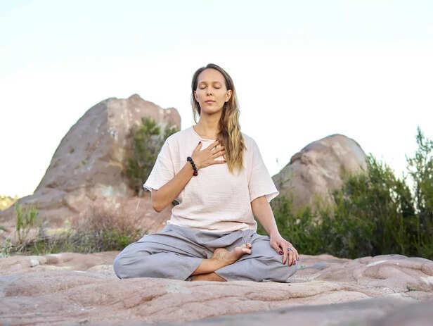 Person practicing mindful breathing outdoors
