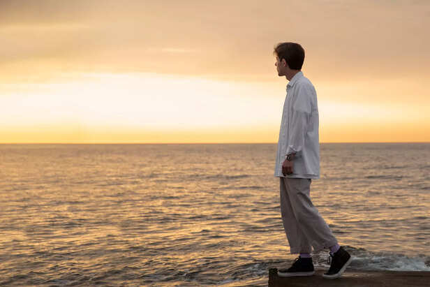 Person walking confidently alone at sunrise