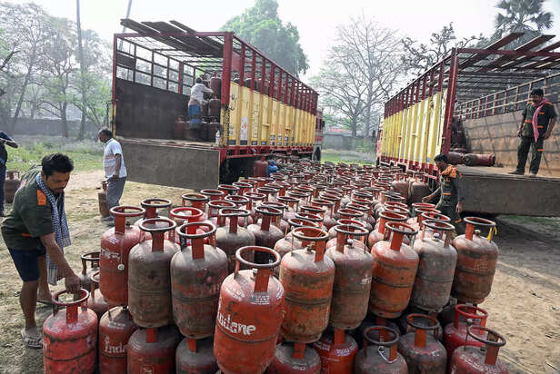 Workers load empty liquefied petroleum gas (LPG) cylinders ...