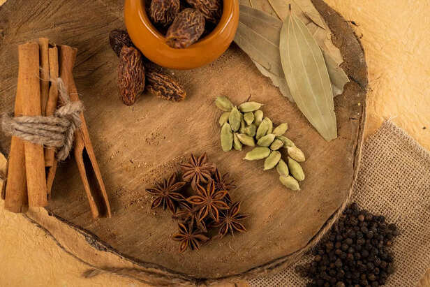 Ayurvedic herbs and spices on wooden table
