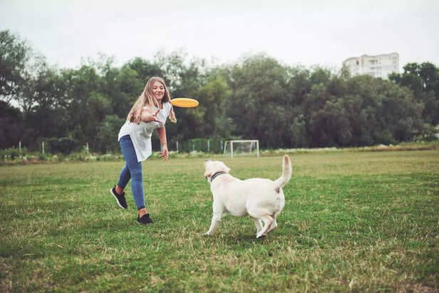 girl playing with pet