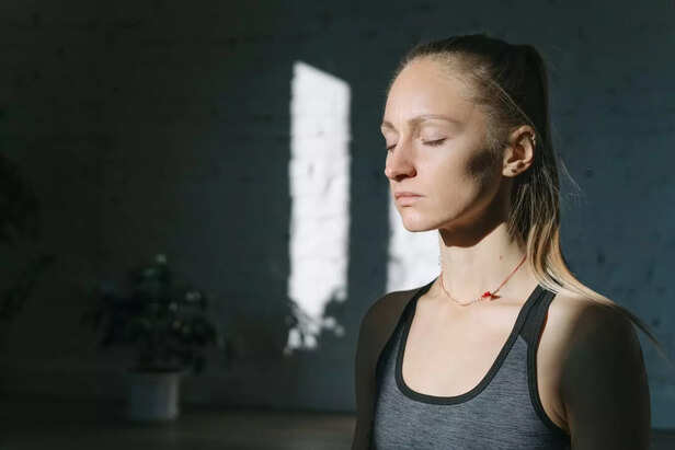 Person Closing Eyes Taking Deep Breath