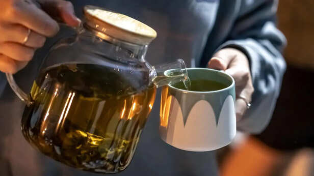 Pouring Tea Into a Cup