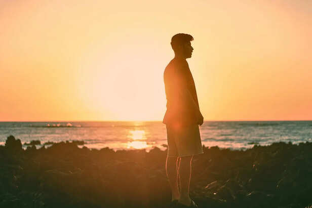 Person standing calm during sunset