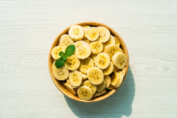 Banana slices in wooden bowl
