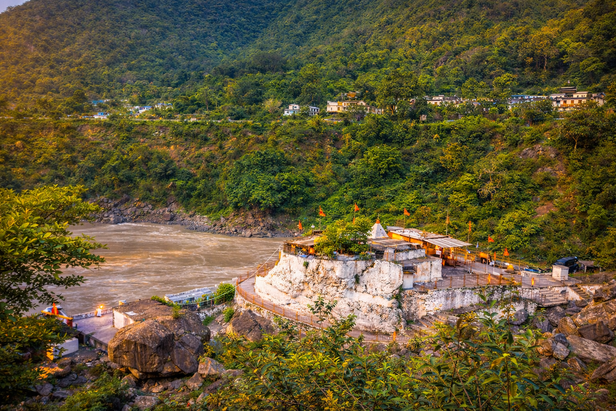 Temple by the river in lush mountains