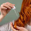 A Women Oiling her Hair             (Image Credit :Pexels)