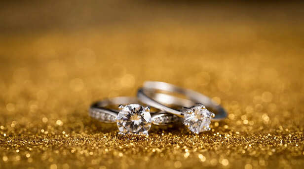 Two diamond rings on a golden surface
