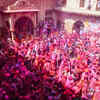 Vrindavan, Mar 02 (ANI): People play Holi with flower petals and colours as part...