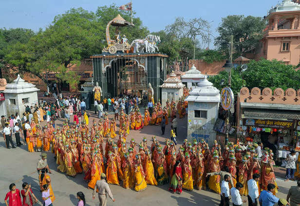 Mathura, Mar 24 (ANI): Women devotees carry pots during a religious procession t...