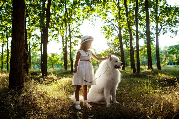 Young girl walking with dog