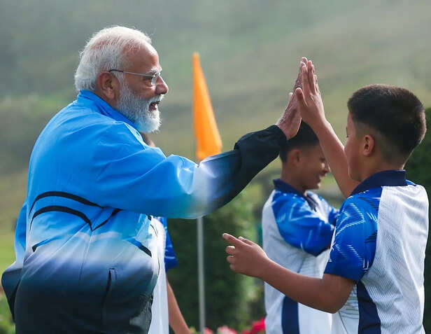 Prime Minister Narendra Modi plays football with youngste...