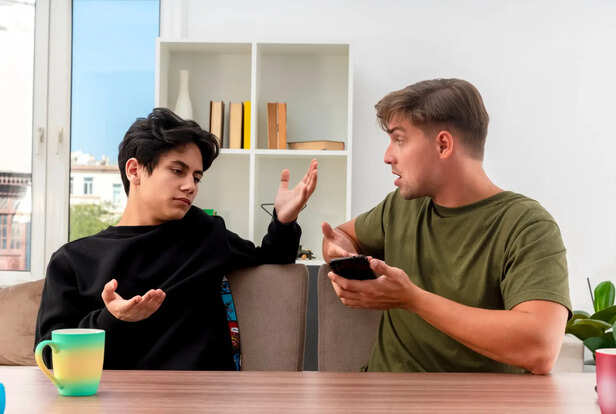 Person Reacting Defensively During Conversation