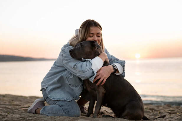 Woman hugging her pitbull