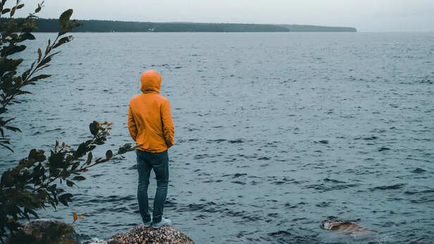 A solitary man in a yellow jacket