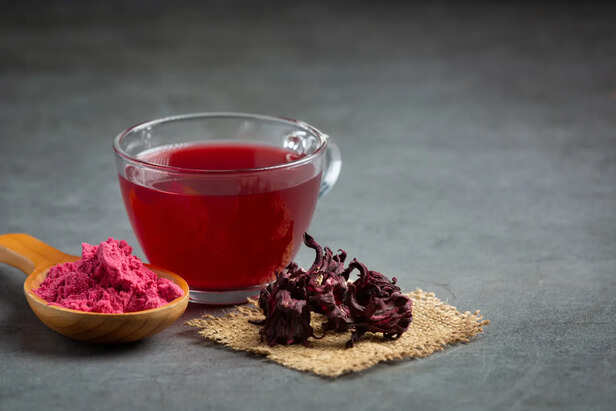 Homemade hibiscus paste being mixed into warm oil