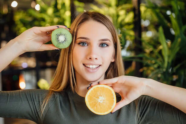 Healthy glowing skin beside antioxidant-rich fruits