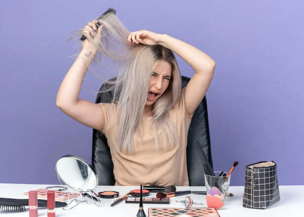 Damaged hair strands beside chemical dye products