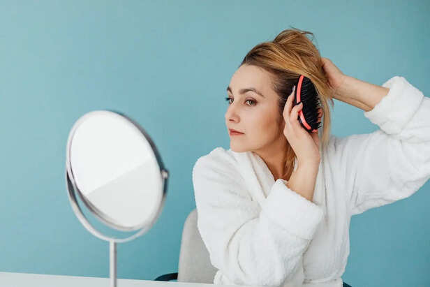 Woman Brushing Wet Hair Aggressively