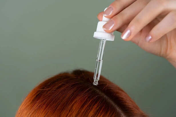 Warm Oil Being Applied to Hair