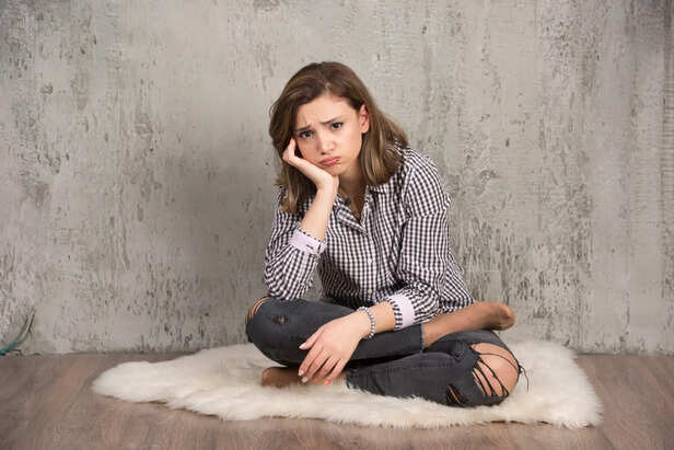 Woman Sitting Alone Thinking Deeply